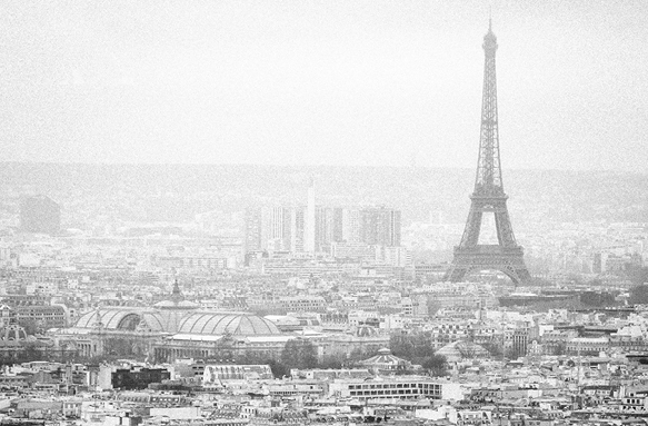 A grey-scale, landscape image of Paris from 1937. The Eiffel tower can be seen to the right.